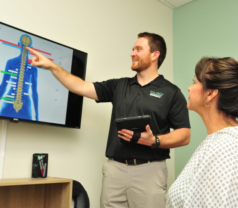 Wichita Chiropractor discussing spine diagram with patient
