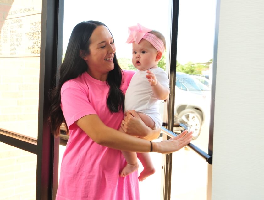 Wichita patient and her baby entering the Full Circle Chiropractic office