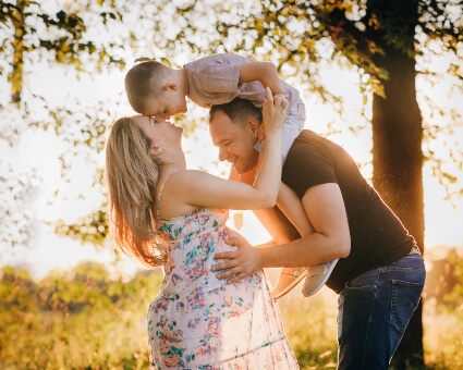 Pregnant woman with husband and young child