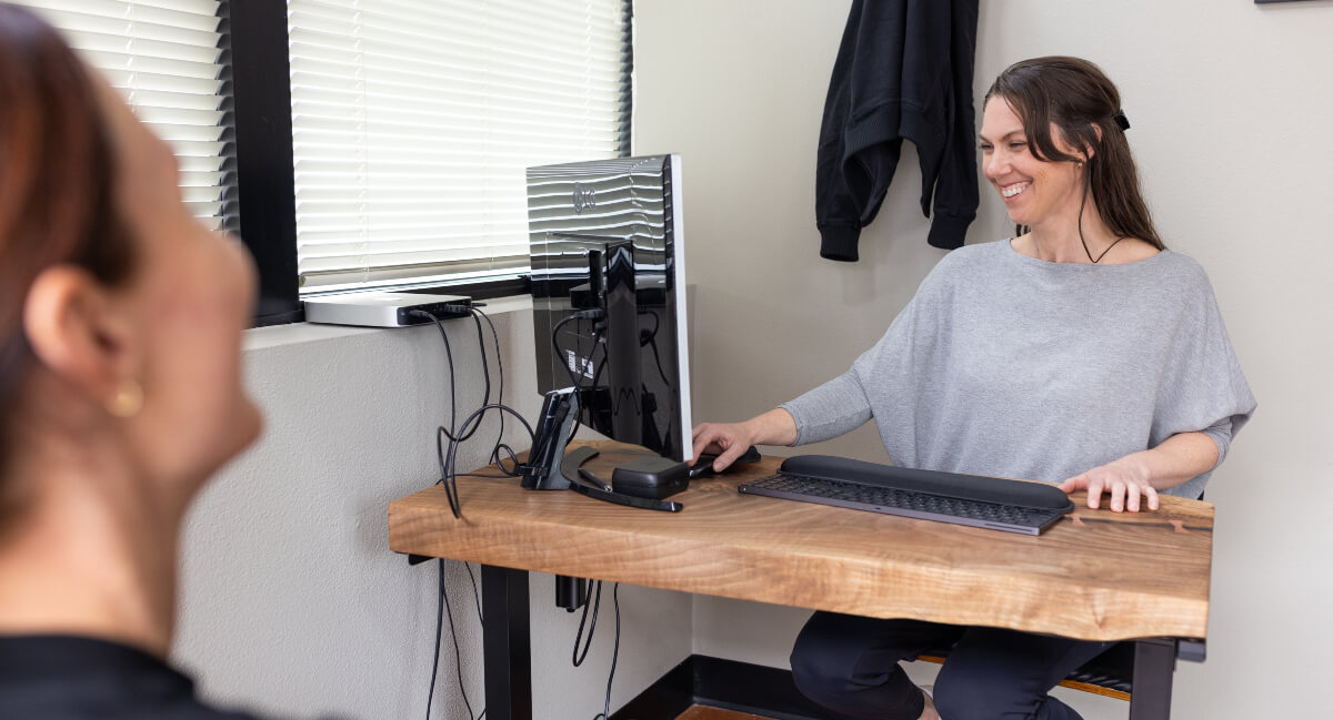 Portland chiropractor Dr. Whitney in consultation with patient