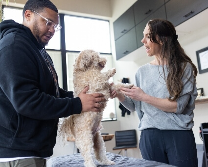 Portland chiropractor in consultation with dog and owner