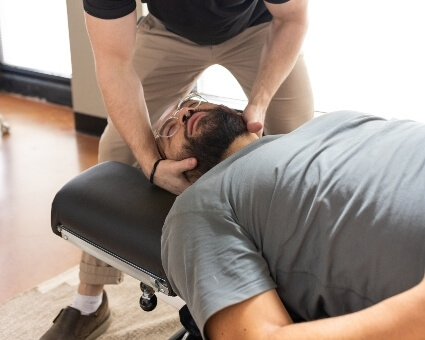 Portland patient getting neck adjustment at Move Better