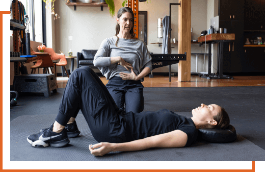 Portland chiropractor Dr. Whitney Phillips teaching breathing exercises to patient