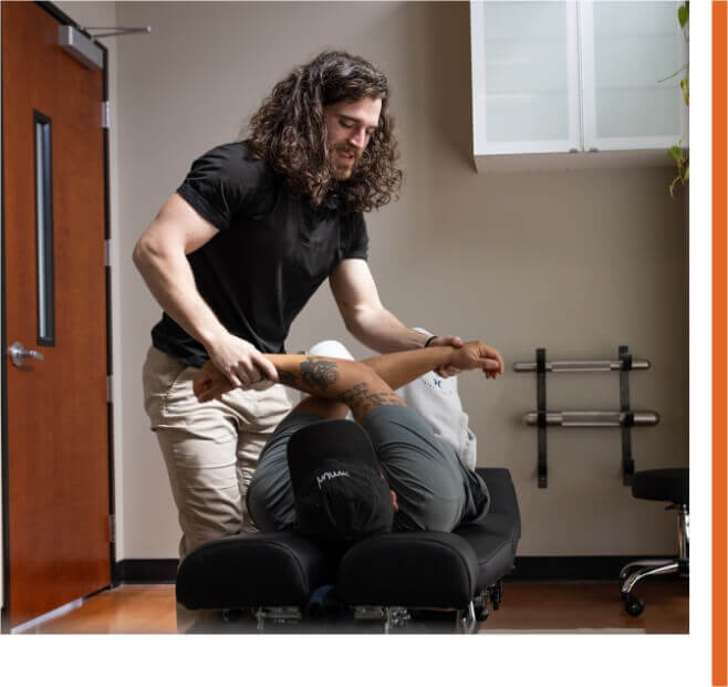 Portland chiropractor Dr. Zachary Cullen giving a chiropractic adjustment to male patient