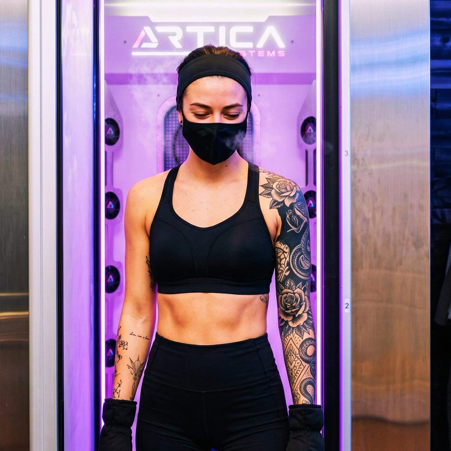 woman in front of cryotherapy chamber