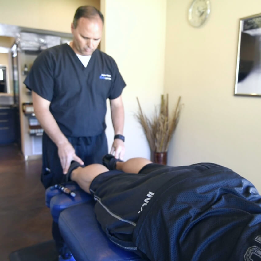 Dr Watson adjusting patients legs