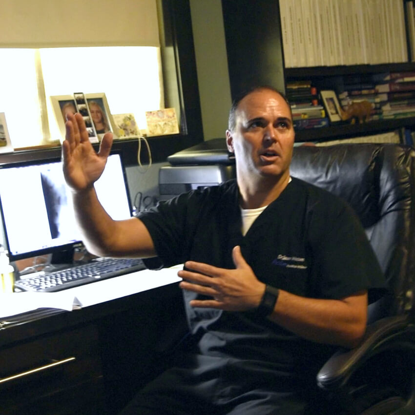 Boise chiropractor Dr Watson talking in front of a computer