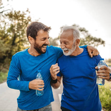 men walking holding bottled water