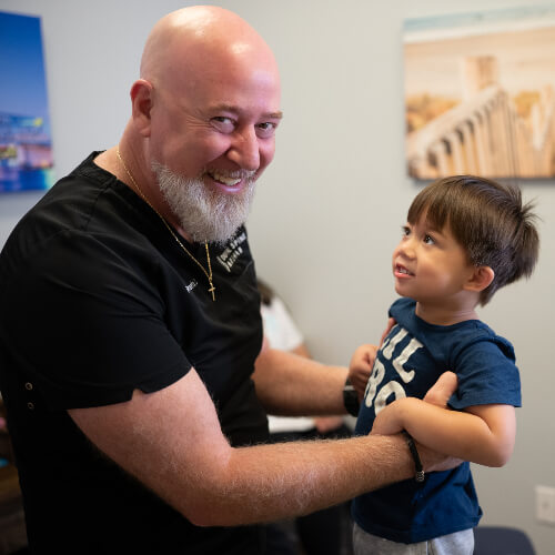 Chiropractor holding a young child
