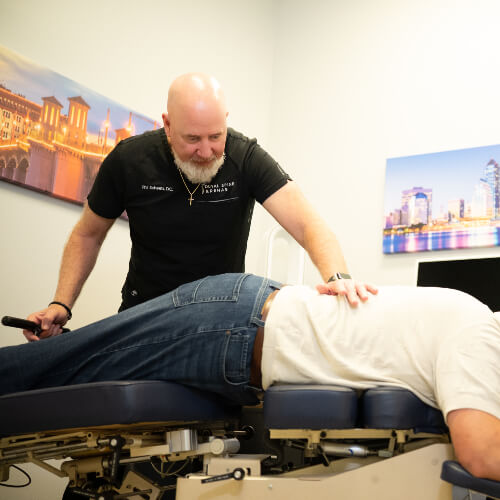 Chiropractor pushing on patient's back