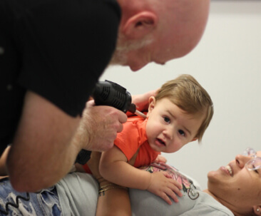 child being adjusted with tool