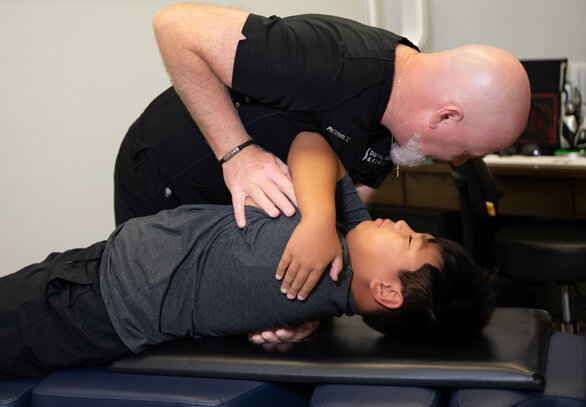 Female patient receiving a back adjustment