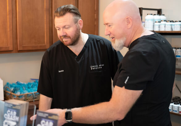 Chiropractor adjusting patient's shoulder