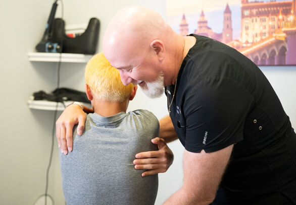 Female patient treated with chiropractic leg adjustment