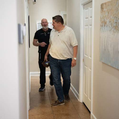 Chiropractor and patient walking in hallway