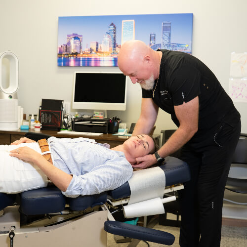 doctor adjusting persons neck