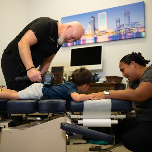 Mom and young child in chiropractic cionsultation
