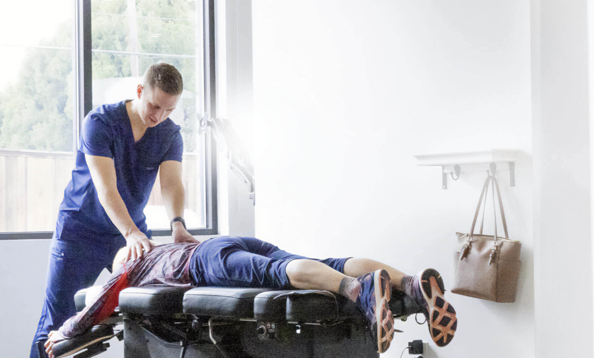 Chiropractors adjusting patient