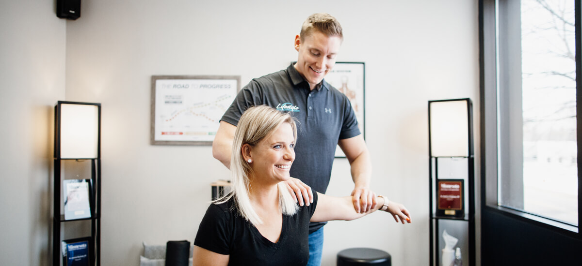 Mendota Heights Chiropractor Dr. Andrew doing shoulder adjustment