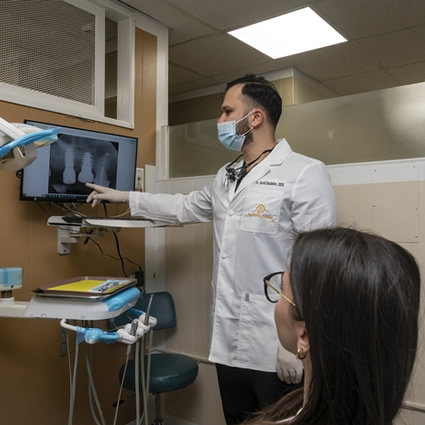 Dentist pointing to xray
