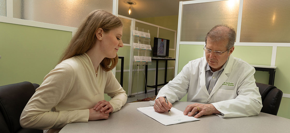doctor reviewing paperwork with patient