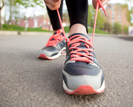 person tying running shoes