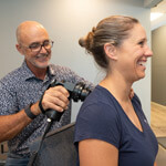 Dr Kevin and female patient smiling during treatment