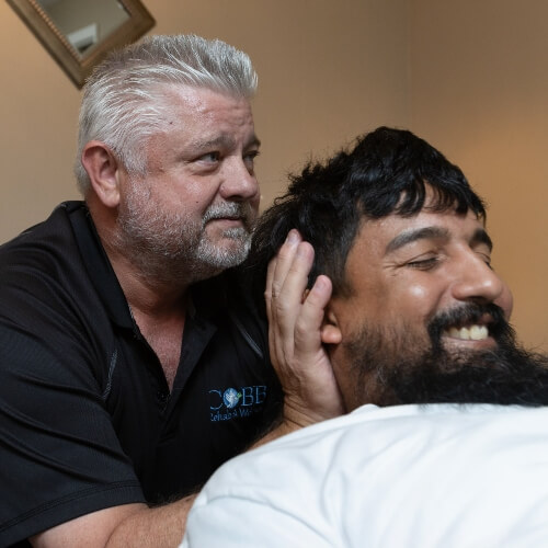 Tampa chiropractor adjusting patient's neck