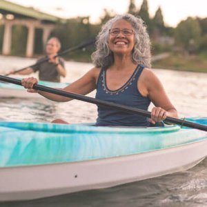 woman smiling  and kayaking