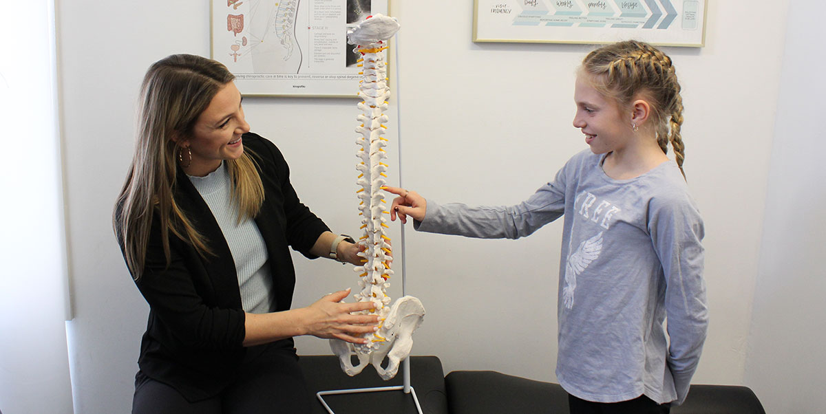 Dr. Julia holding spine model