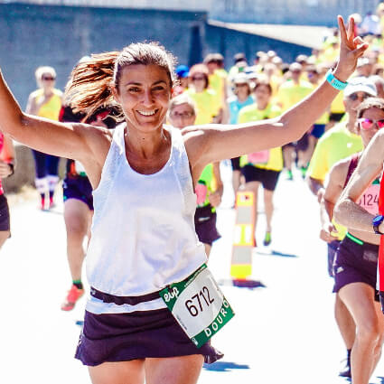 woman smiling while running marathon