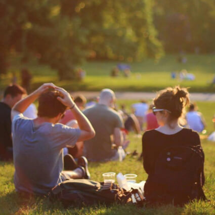 two people sitting outdoors having a picnic