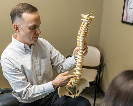 pointing at spine model