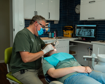 Dr Joshua working in patient's mouth