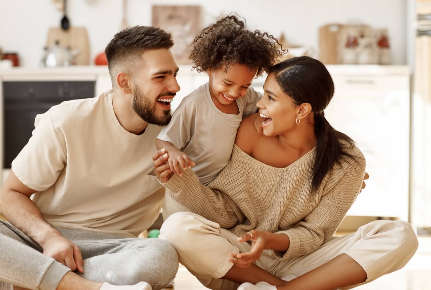 young family sitting and smiling
