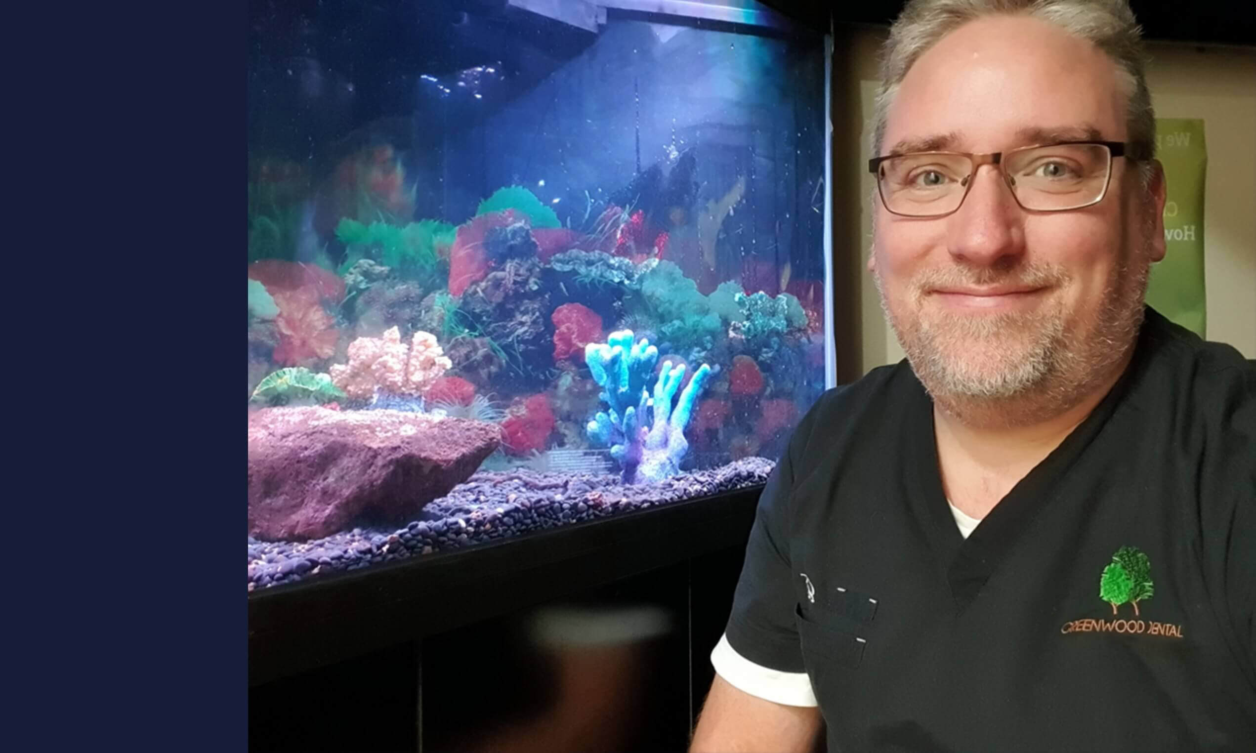 dr josh voweles standing by aquarium