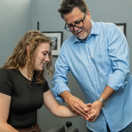 Arlington Heights chiropractor Dr Kevin adjusting persons hand