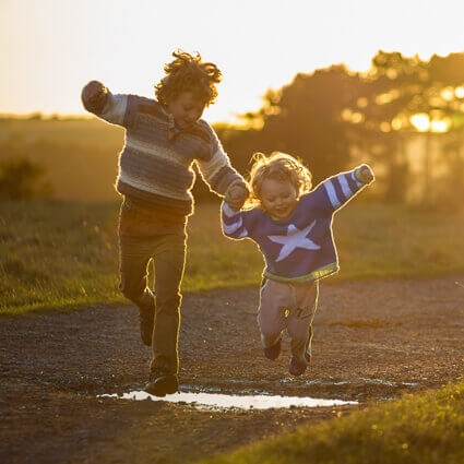Kids jumping in puddles