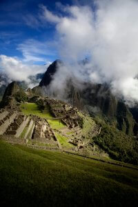 Breathtaking capture of Machu Picchu with dramatic clouds and mountains in Peru.
