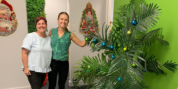 Dr Sheree and woman next to christmas tree