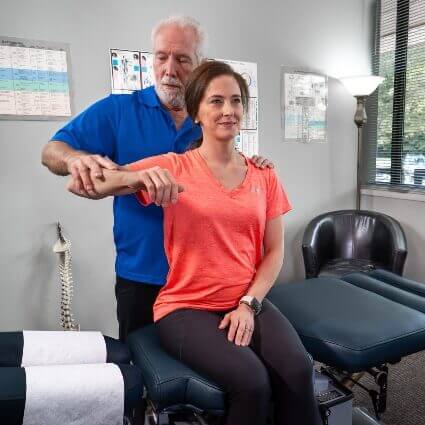 Dr. Philip treating patient with Applied Kinesiology