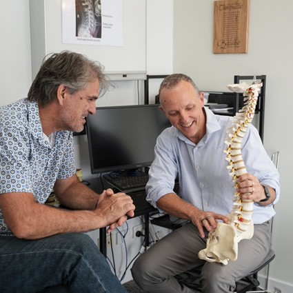Doctor holding spine model
