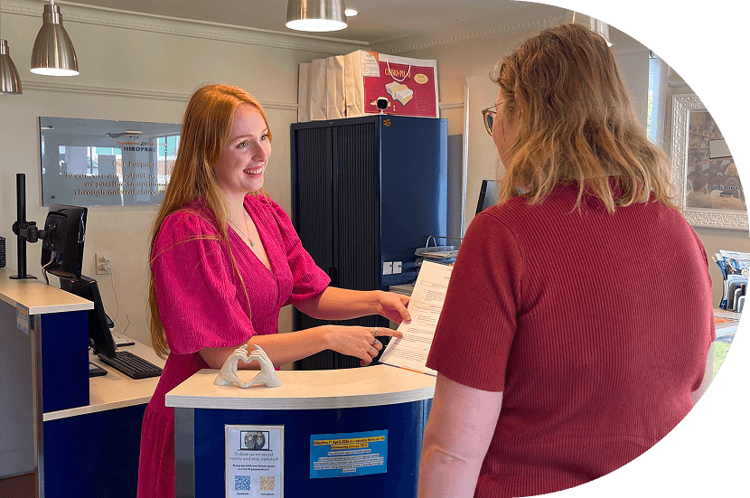 discussing paperwork at reception desk