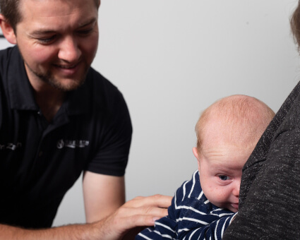 Nampa Chiropractor Dr. Zach adjusting baby