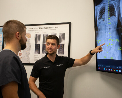 Chiropractor pointing to xray