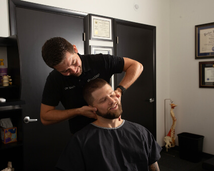 True North Chiropractic and Wellness Chiropractor Dr. Zach adjusting neck