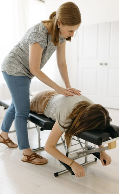 Chiropractor adjusting patients