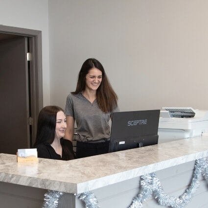 team and chiropractor at our front desk
