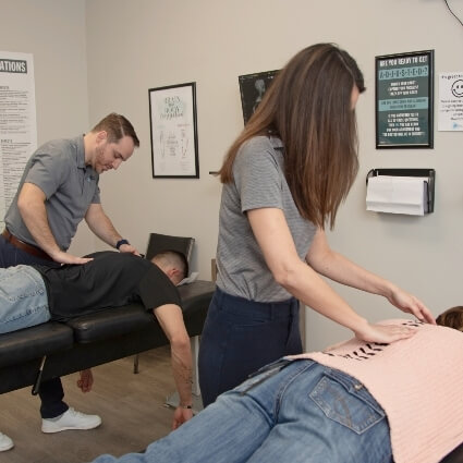 our doctors adjusting patients on tables