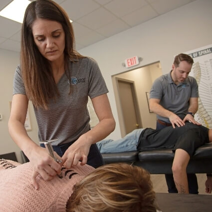 our doctors adjusting patients on tables